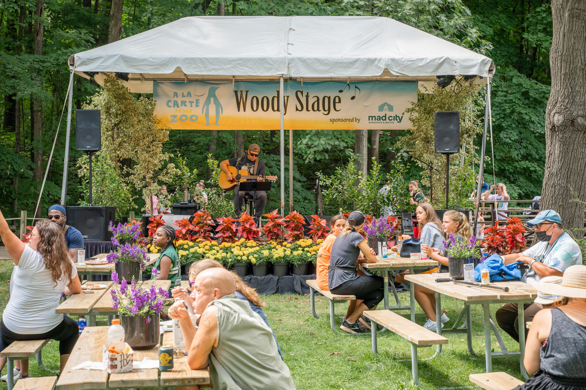 Guests eating and enjoying music at the Woody Stage during Milwaukee a la Carte
